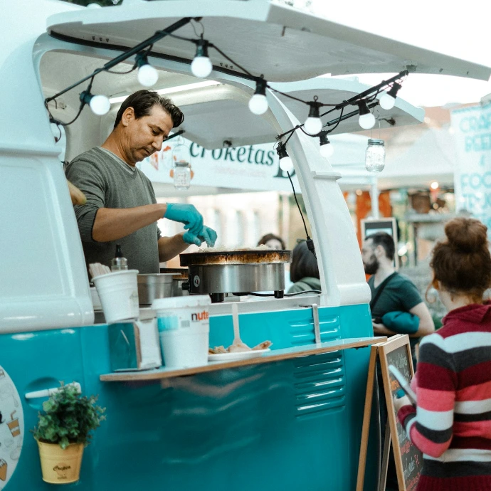 Small business food truck serving a customer